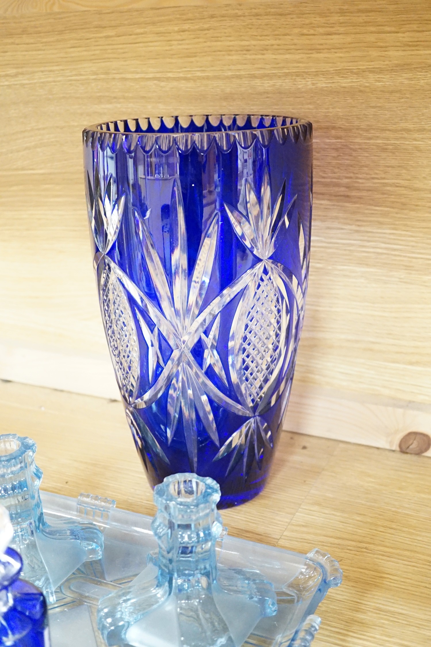 A group of mostly blue glass, largest item engraved vase 32cms high